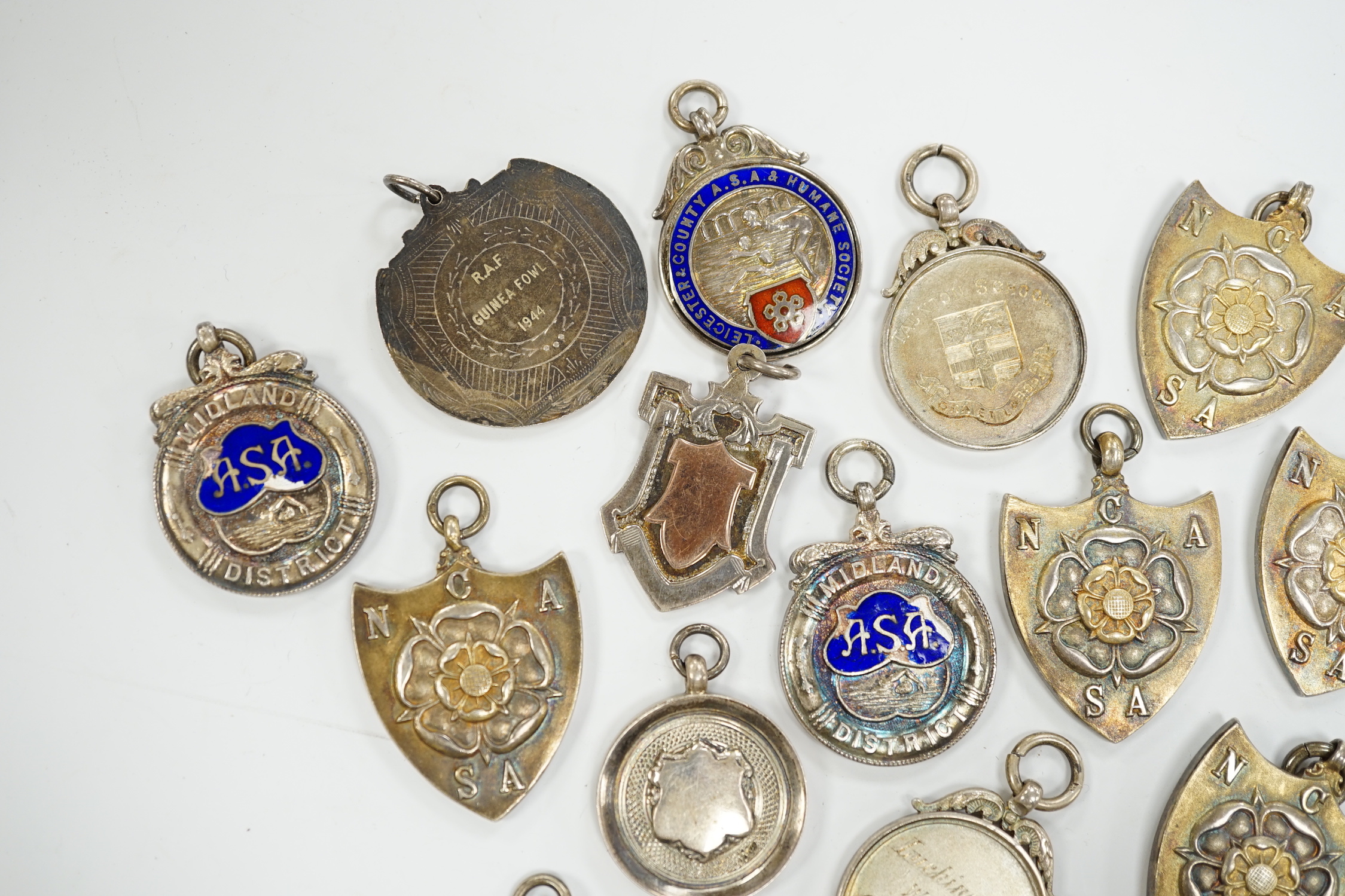 Twelve assorted mainly mid 20th century silver medals, including running and swimming (three with enamel) and two other white metal medals.